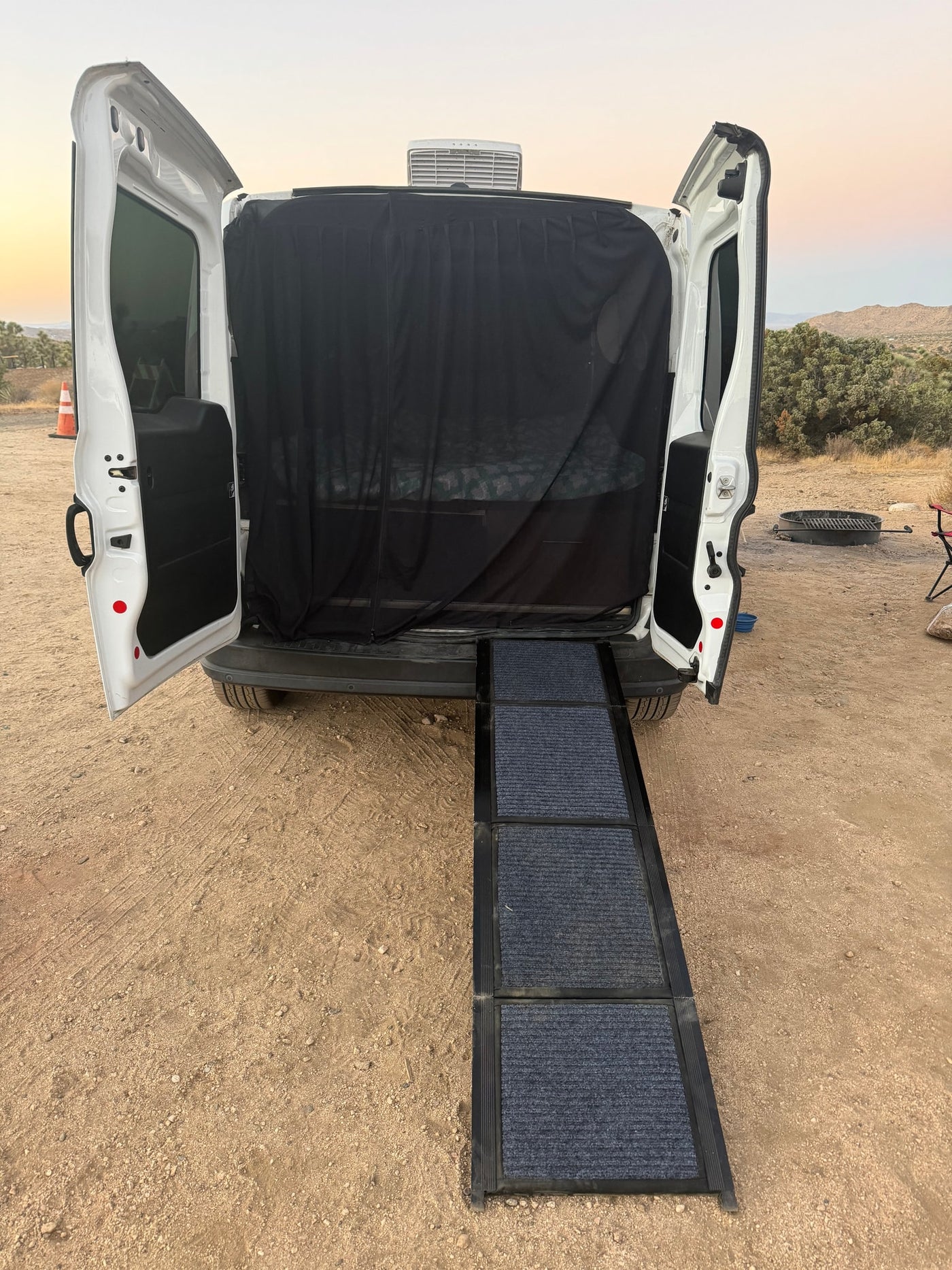  parked by a river at sunset with a dog by the water's edge. Peaceful outdoor scene.|Inside an rv rental: rustic wooden interior — photo 5