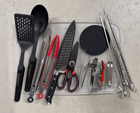 This RV rental essential kit includes diverse kitchen and grilling utensils: a spatula, spoon, tongs, knife, shears, whisk, openers, and skewers.