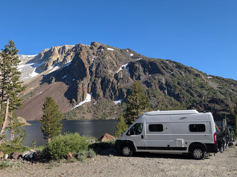 This rv rental camper van is parked lakeside — photo 1