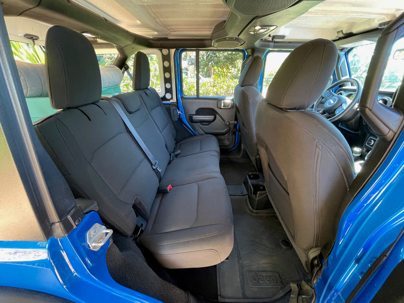 Spacious blue Jeep interior for your next rv rental adventure. Features comfortable rear seating and rugged floor mats. — photo 3