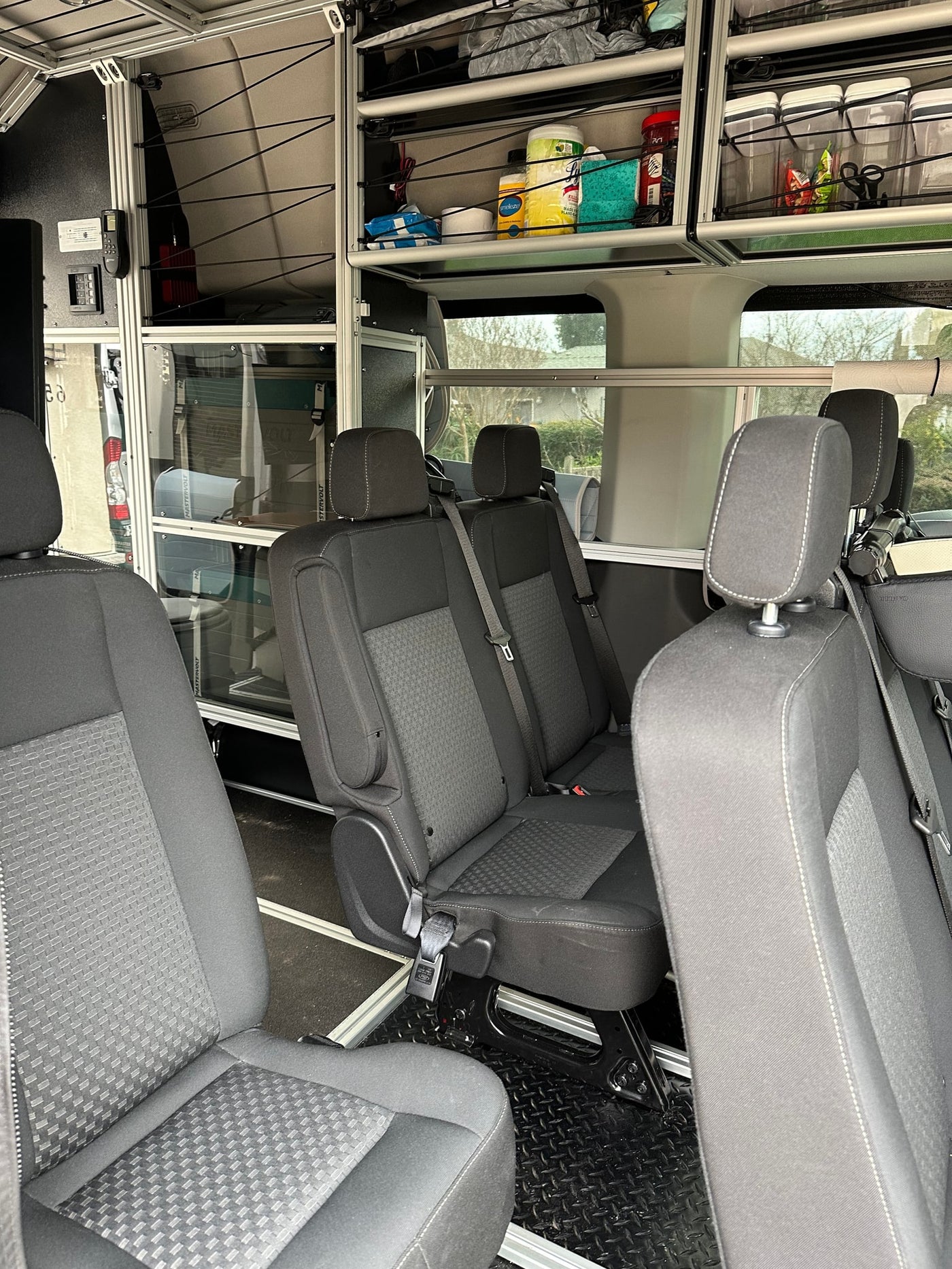  and a wireless charger inside a camper van.|RV rental's interior: dual monitors — photo 4