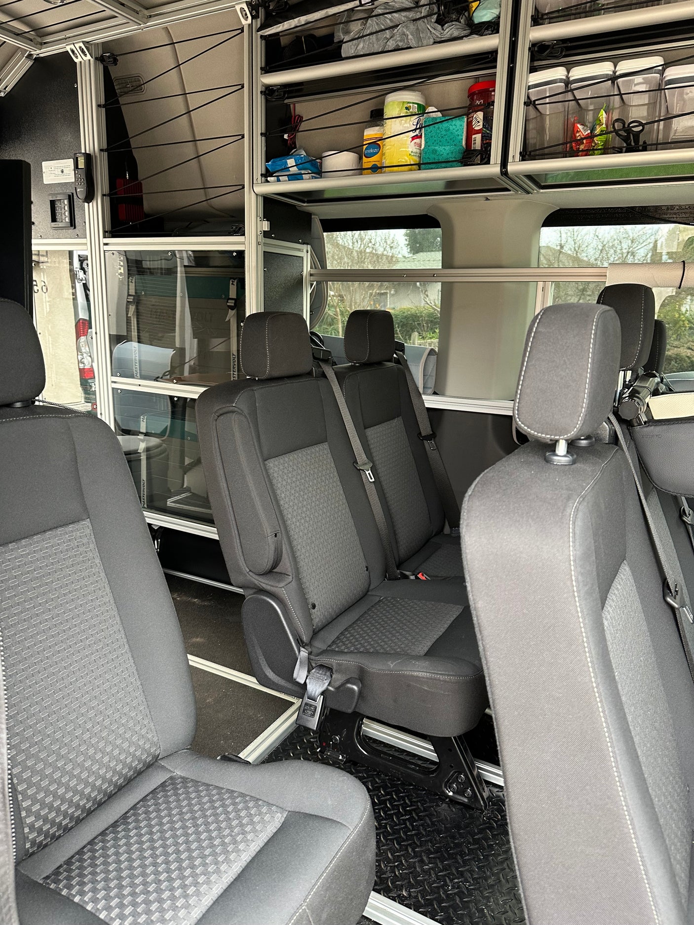 Spacious rv rental van interior featuring comfortable passenger seating and practical modular storage shelves.