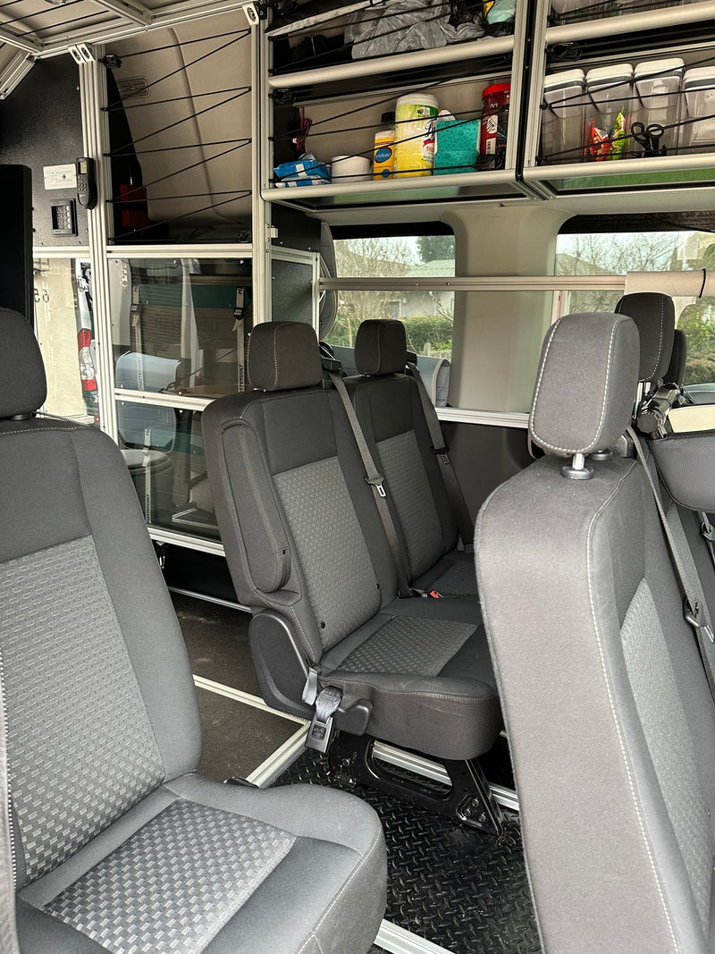  and a wireless charger inside a camper van.|RV rental's interior: dual monitors — photo 4