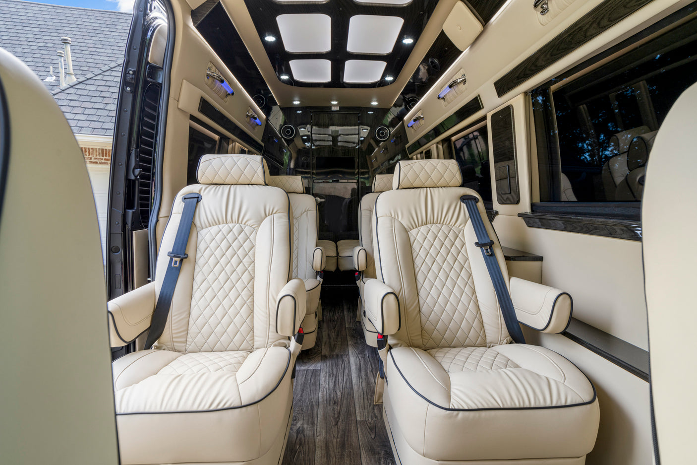Step into luxury: this RV rental features plush cream seats, dark wood floors, and ambient lighting for premium travel.