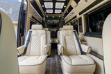 Step into luxury: this RV rental features plush cream seats, dark wood floors, and ambient lighting for premium travel.