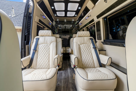 Step into luxury: this RV rental features plush cream seats, dark wood floors, and ambient lighting for premium travel.