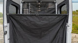 RV rental showing open rear doors with a black privacy screen, creating an outdoor changing room or shower. Ideal for camping.