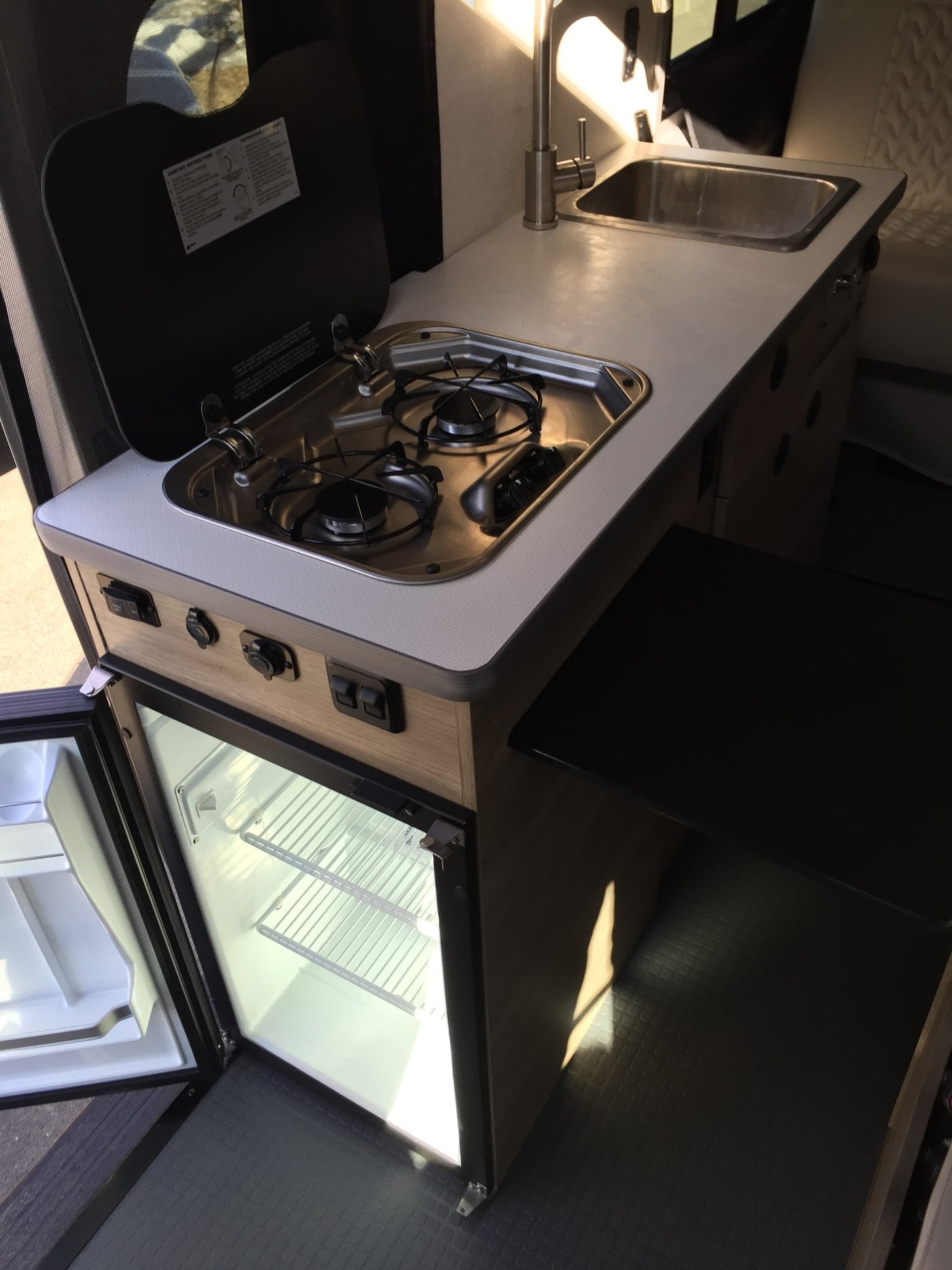  and front passenger seat.|Inside an RV rental: compact interior with light seats — photo 7