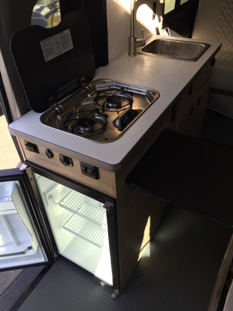  and front passenger seat.|Inside an RV rental: compact interior with light seats — photo 7