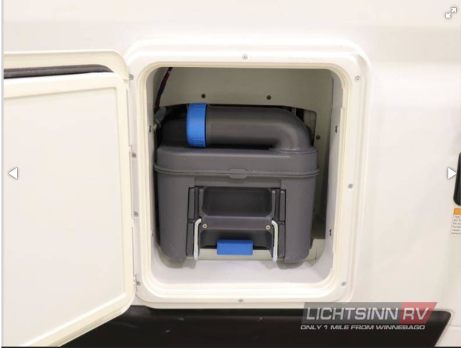 RV rental: Exterior access to a removable cassette toilet waste tank for easy waste disposal.