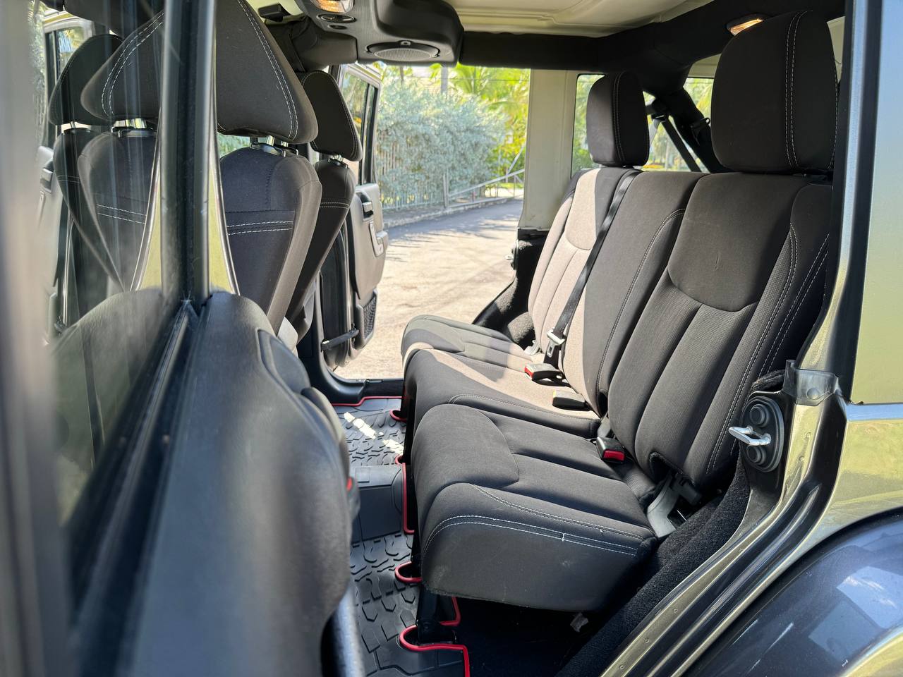 Spacious rear seats of this adventure-ready SUV, perfect for your next rv rental trip. View shows black fabric seats & floor mats. — photo 16