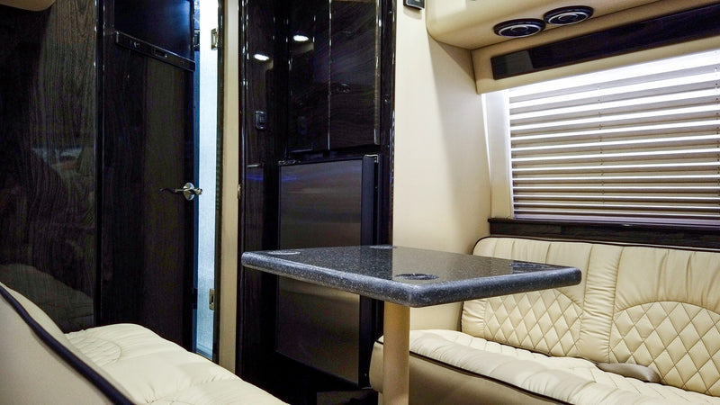 Luxury RV rental interior with cream leather benches — photo 1