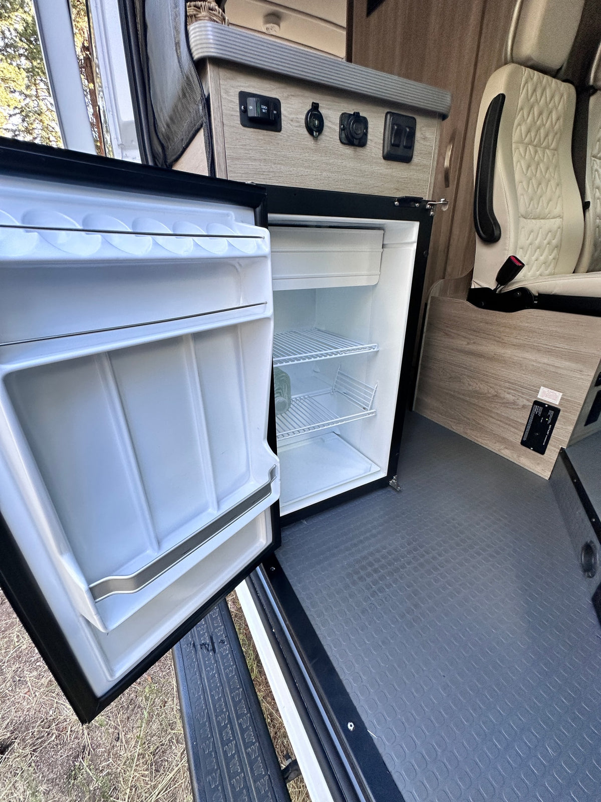  and a dark gray driver's seat.|Explore this RV rental's interior: driver's cockpit — photo 11