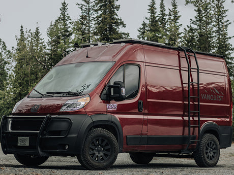Experience adventure! This rugged maroon Ram ProMaster camper van, with a roof rack & ladder, is a great **RV rental** option.