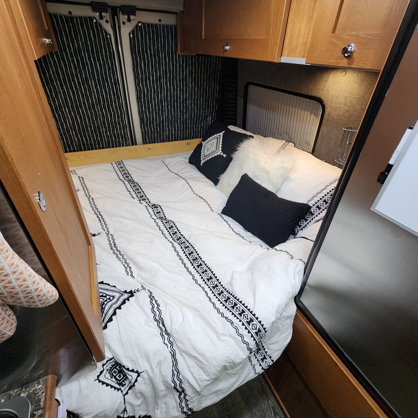  and a welcoming 'hello' mat at the door.|Cozy RV rental interior with a well-equipped kitchen — photo 13