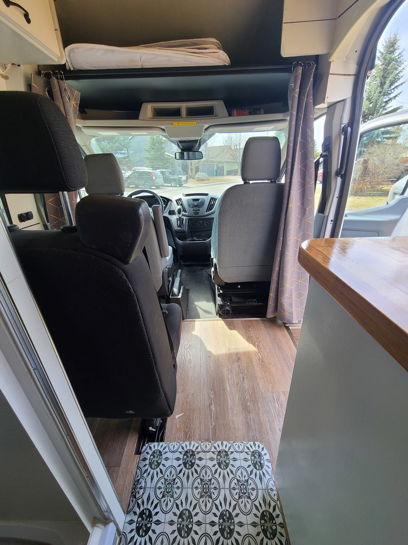 Comfortable RV rental interior: view from rear, showcasing custom curtains, wood flooring, and the driver's cab. Ideal for road trips. — photo 20