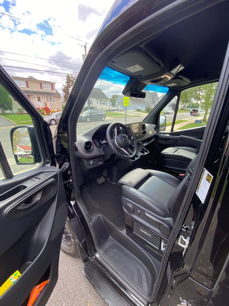 This RV rental offers a luxurious and spacious interior, seen from the open door showing the driver's cockpit.