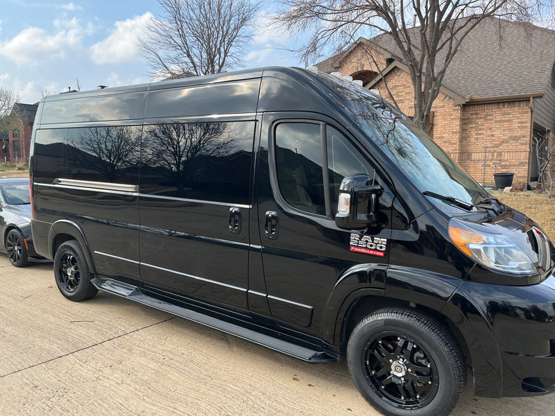 Black Ram 2500 ProMaster van, an excellent RV rental option, with custom wheels and running boards. — photo 9