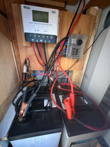 RV rental power system: Solar charge controller (13.5V), fuse box, and two Lifeline batteries, showing wiring setup.