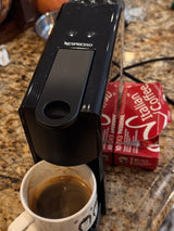 Nespresso machine making fresh Italian coffee in a mug, perfect for a cozy RV rental morning.