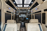 Inside a luxurious RV rental: Cream quilted seats, dark wood, ambient lighting, and window blinds for comfort.