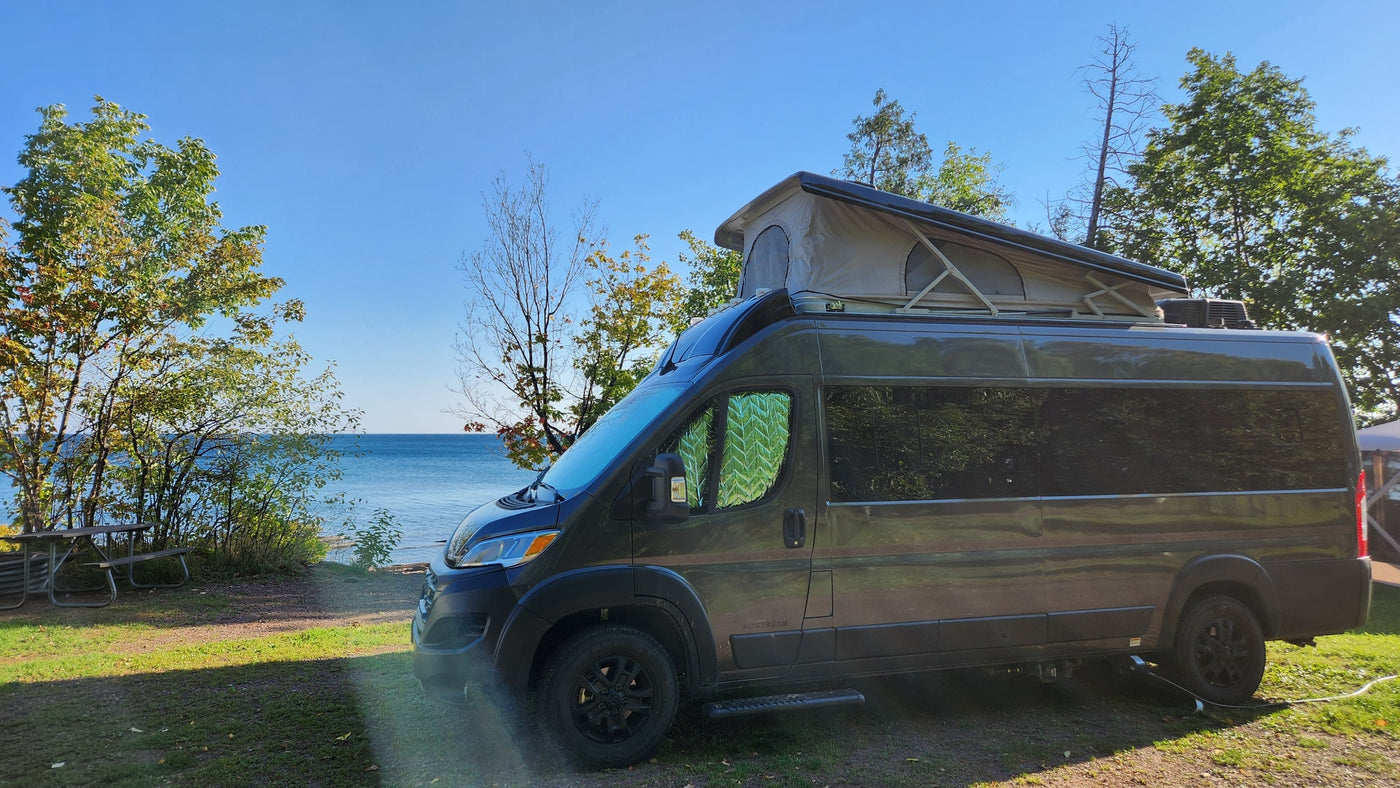Enjoy lakefront views in an RV rental! This dark camper van with a pop-top is ready for adventure by the water. — photo 6