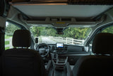 Step into this RV rental! Interior view of the driver's cockpit, steering wheel, and dashboard, ready for a scenic road trip.