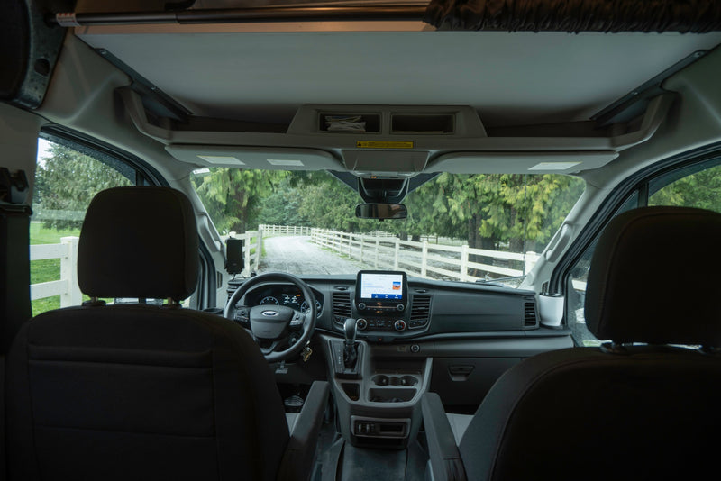 Step into this RV rental! Interior view of the driver's cockpit, steering wheel, and dashboard, ready for a scenic road trip. — photo 32