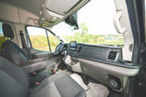 Experience the comfortable front cabin of this RV rental van, featuring a modern dashboard and spacious seating.