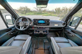 Experience a Mercedes Sprinter rv rental. Detailed cabin view: dashboard, steering wheel, front seats, and desert scenery.