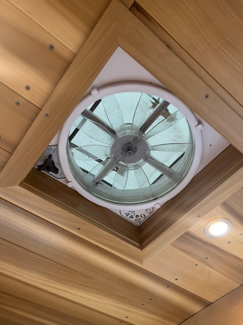RV rental ceiling: a functional fan/vent with a mesh screen, framed by warm wood paneling, plus a bright LED light. — photo 14