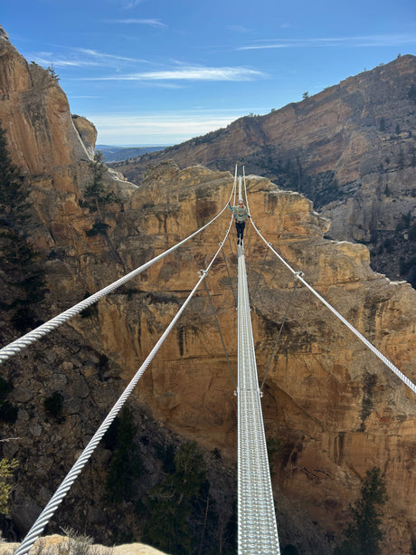 Navigating a thrilling canyon suspension bridge. Explore epic views like this easily with an RV rental.