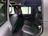 Inside view of a roomy vehicle, potentially for an rv rental. Shows black rear seats, overhead lights, and door details.