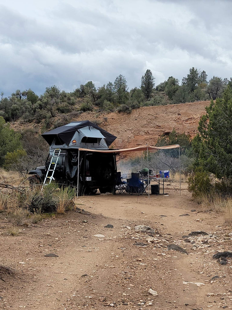  hilly terrain. Your next outdoor adventure or scenic RV rental trip awaits!|Black Jeep with a deployed rooftop tent & ladder — photo 4