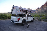 Desert overlanding with a Ford F-150 and Roofnest rooftop tent, a unique RV rental experience for mountain escapes.
