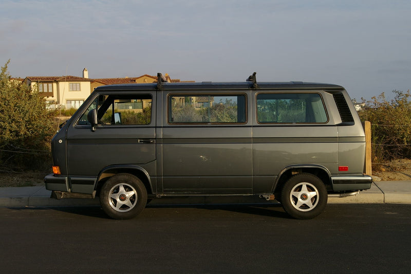 Classic grey VW Vanagon RV, a timeless choice for your next rv rental. Parked on a street near houses. — photo 1