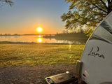 enjoy a beautiful lake view and comfort.|Golden sunrise over a serene lake