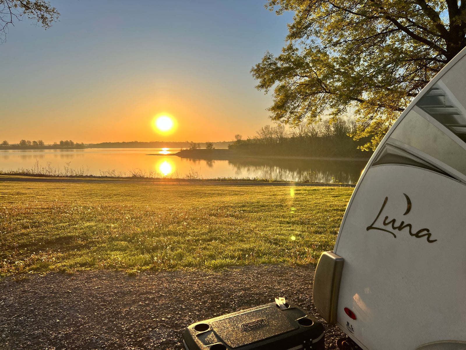  enjoy a beautiful lake view and comfort.|Golden sunrise over a serene lake