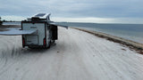Winnebago EKKO RV rental on a sandy beach. Perfect for coastal adventures, awning extended for comfort.