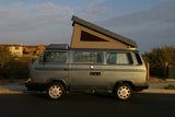 This gray VW camper van with a pop-top roof is perfect for your next RV rental adventure or road trip.