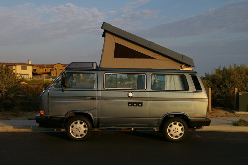This gray VW camper van with a pop-top roof is perfect for your next RV rental adventure or road trip.|View inside an RV rental: functional kitchen with stove and sink — photo 1