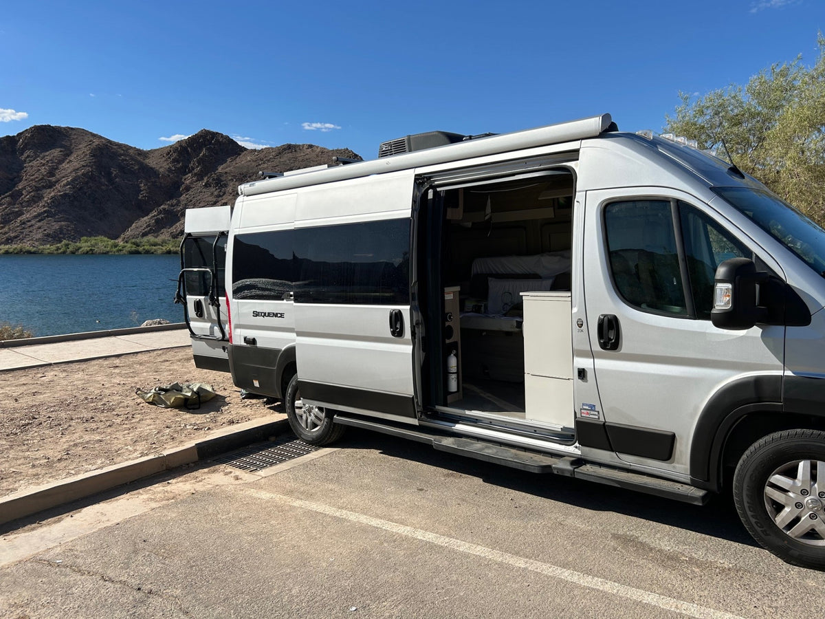  ready for adventure.|White camper van RV rental parked by a lake — photo 11