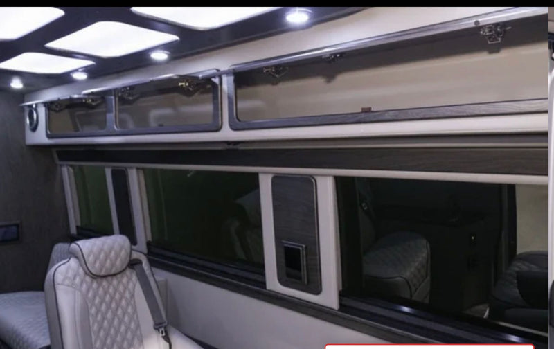 Experience luxury in this RV rental interior: bright overhead lights, glass-front cabinets, and quilted seating for comfort. — photo 9