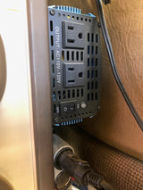 Inside an rv rental, a power inverter with two 110-120V AC outlets and ON/OFF switch, connected to vehicle's 12V.
