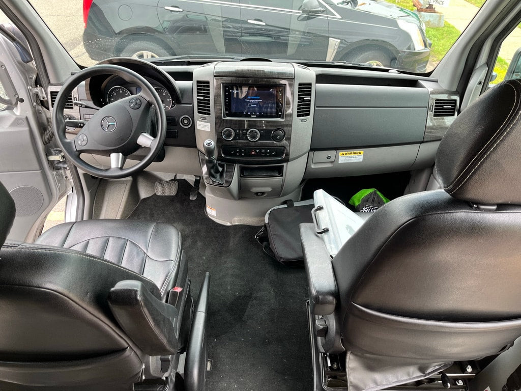  and multi-dispenser.|Spacious RV rental interior with comfortable black leather sofa — photo 11