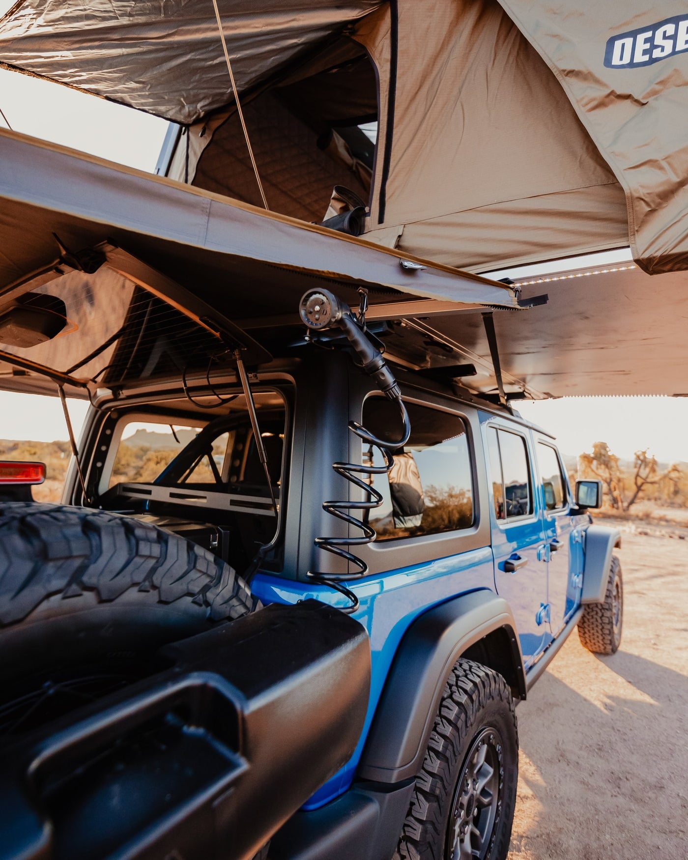 Get ready for off-road camping! Our RV rental, a blue Jeep with rooftop tent & shower, is ideal for outdoor adventures. — photo 9