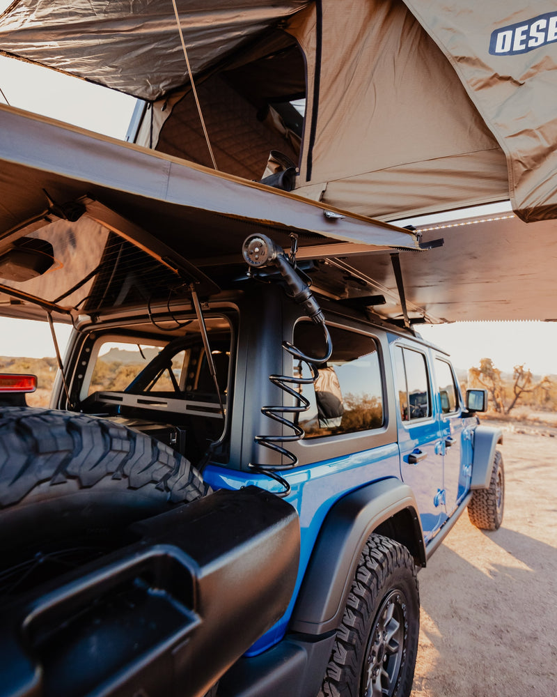 Get ready for off-road camping! Our RV rental, a blue Jeep with rooftop tent & shower, is ideal for outdoor adventures. — photo 9