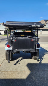 Black overland trailer with OVS rooftop tent, ready for your next rv rental adventure. Perfect for camping!