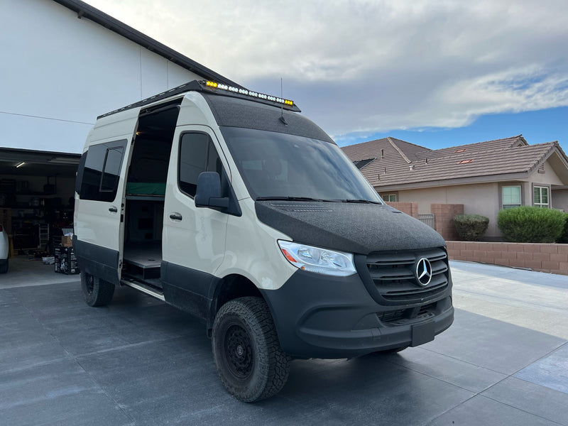  ready for overlanding. Ideal for your next RV rental adventure.|This tan & black off-road camper van (RV rental) with a roof rack & ladder — photo 9