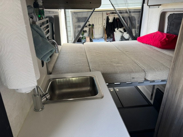  and water utility hookups.|Inside this RV rental: a compact kitchen — photo 12
